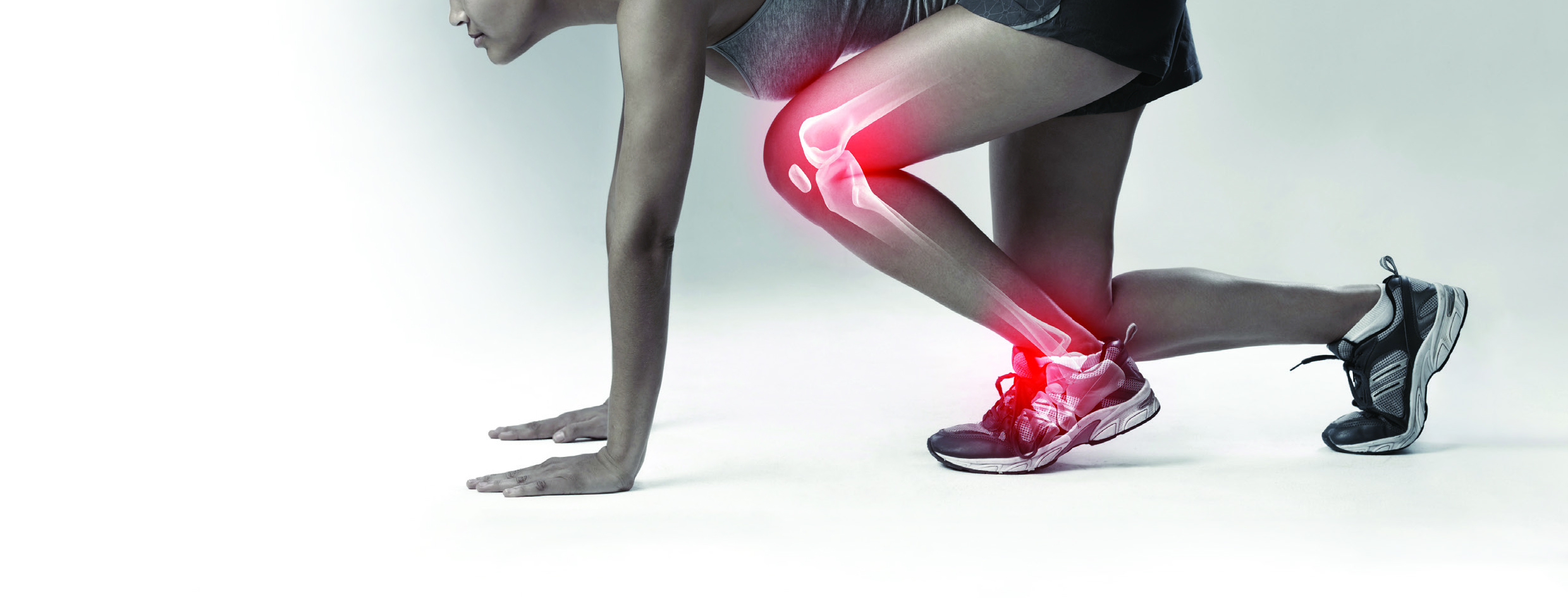 A sprinter in the starting position with the knee and ankle joints highlighted