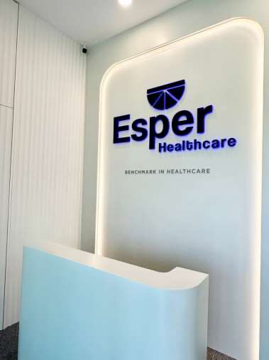 Esper Healthcare reception, with the illuminated logo and Benchmark in Healthcare on the wall